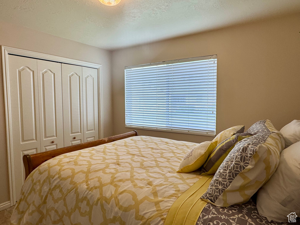 Bedroom featuring a closet and a textured ceiling