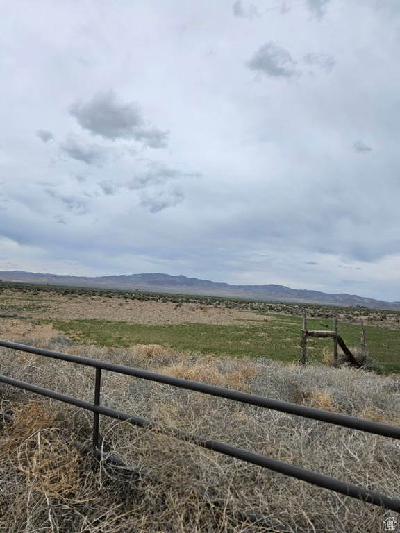 View of mountain backdrop with rural landscape