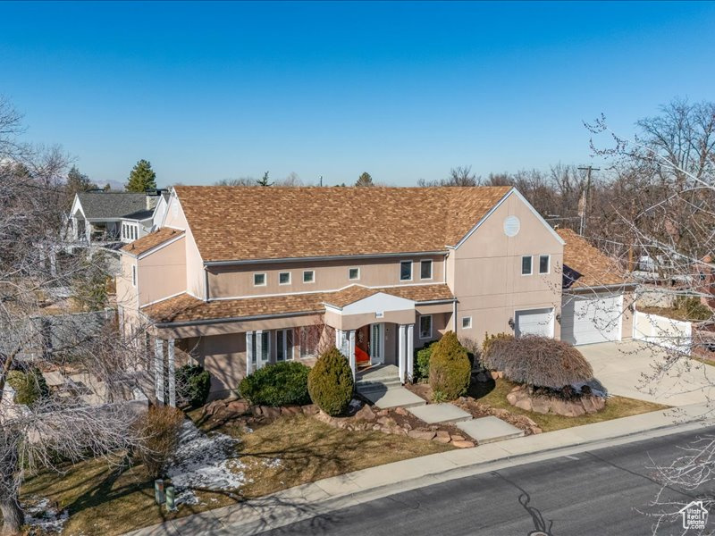 Traditional home featuring concrete driveway, a garage, and stucco siding