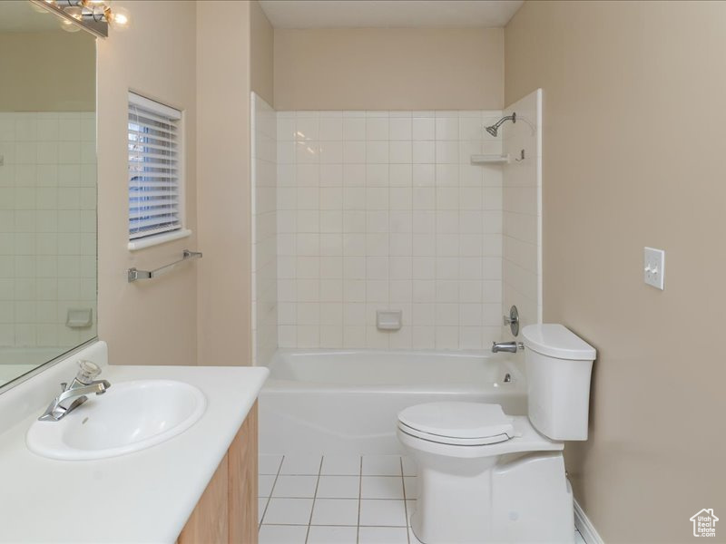 Bathroom with toilet, tile patterned flooring, vanity, and bathing tub / shower combination