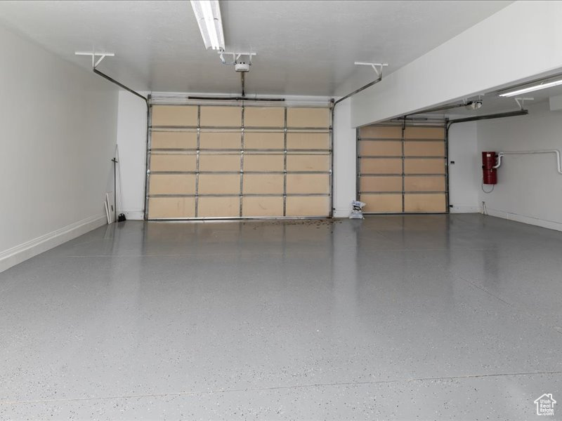 Garage featuring baseboards and a central vacuum unit