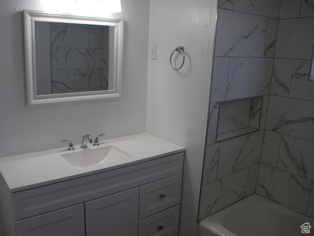 Bathroom with vanity and bathing tub / shower combination