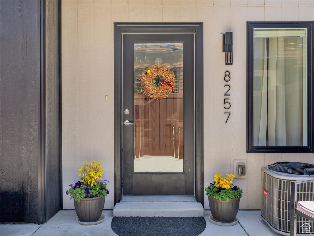 View of exterior entry with central AC unit