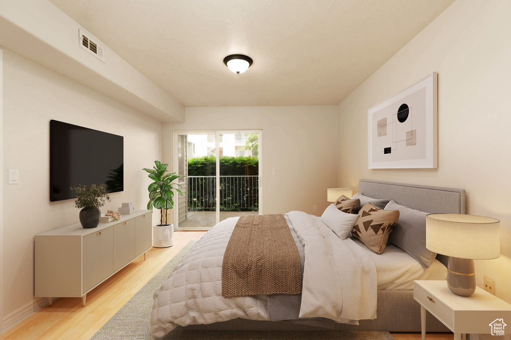 Bedroom with access to outside and light wood-style flooring