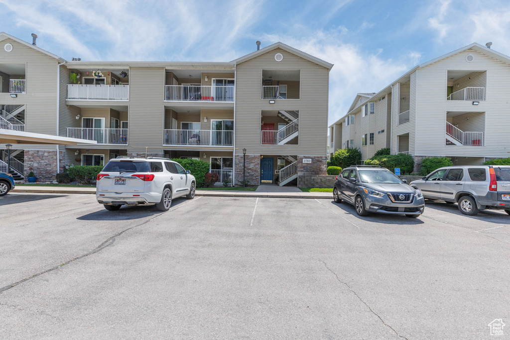 View of building exterior featuring uncovered parking