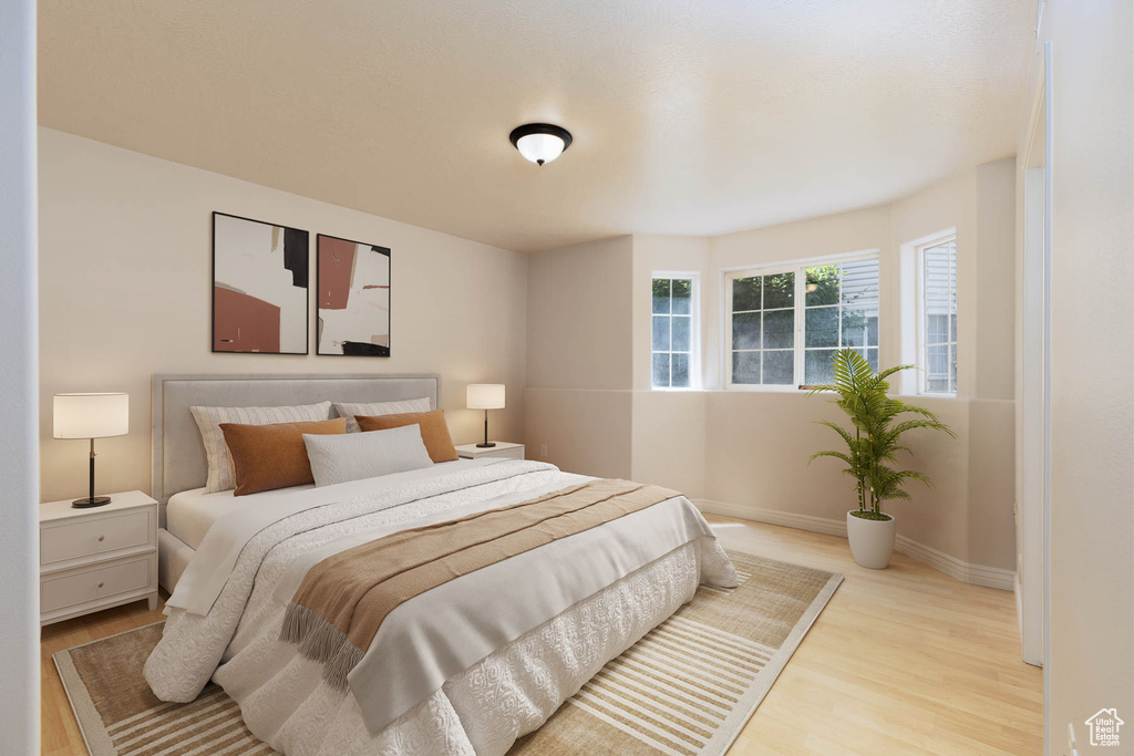 Bedroom featuring wood finished floors and baseboards
