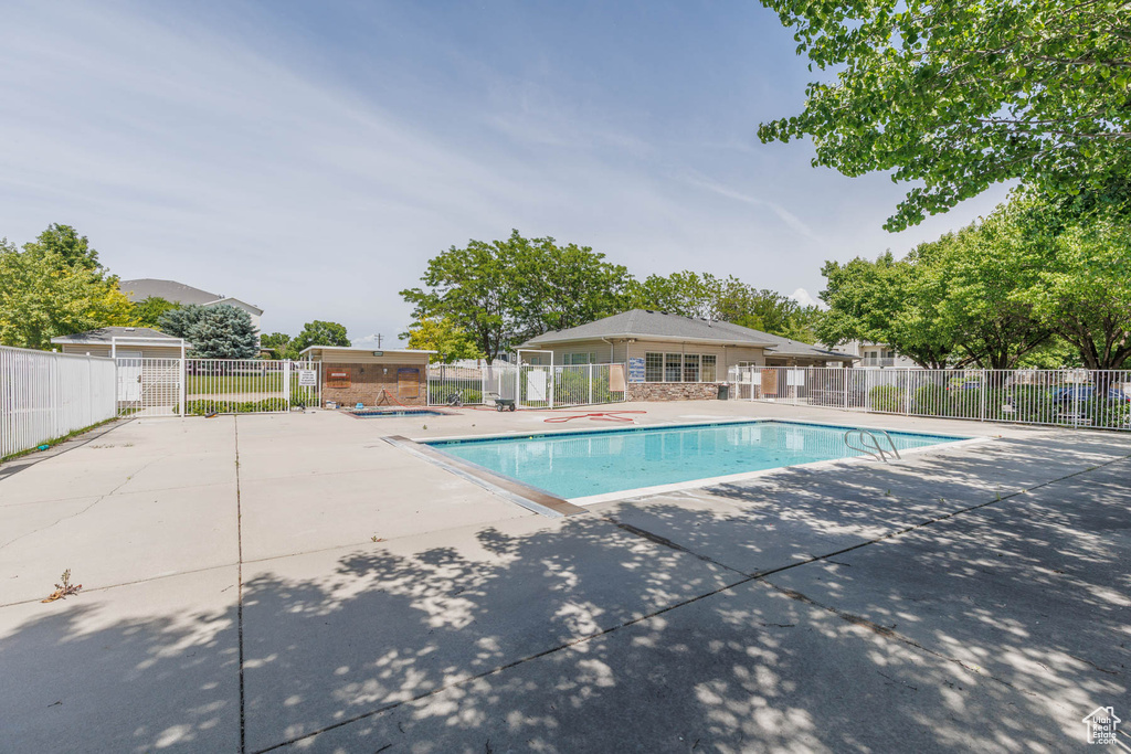 Community pool featuring a patio