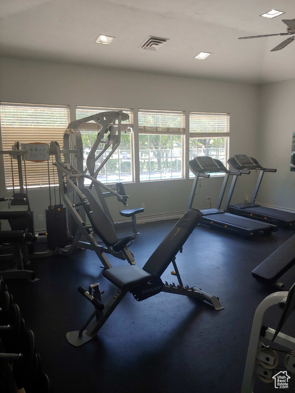 Workout area with ceiling fan and baseboards
