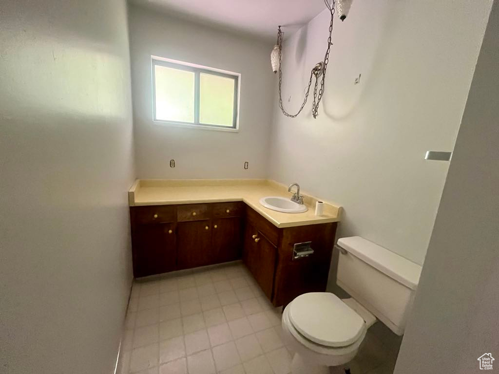 Half bathroom featuring vanity and tile patterned floors