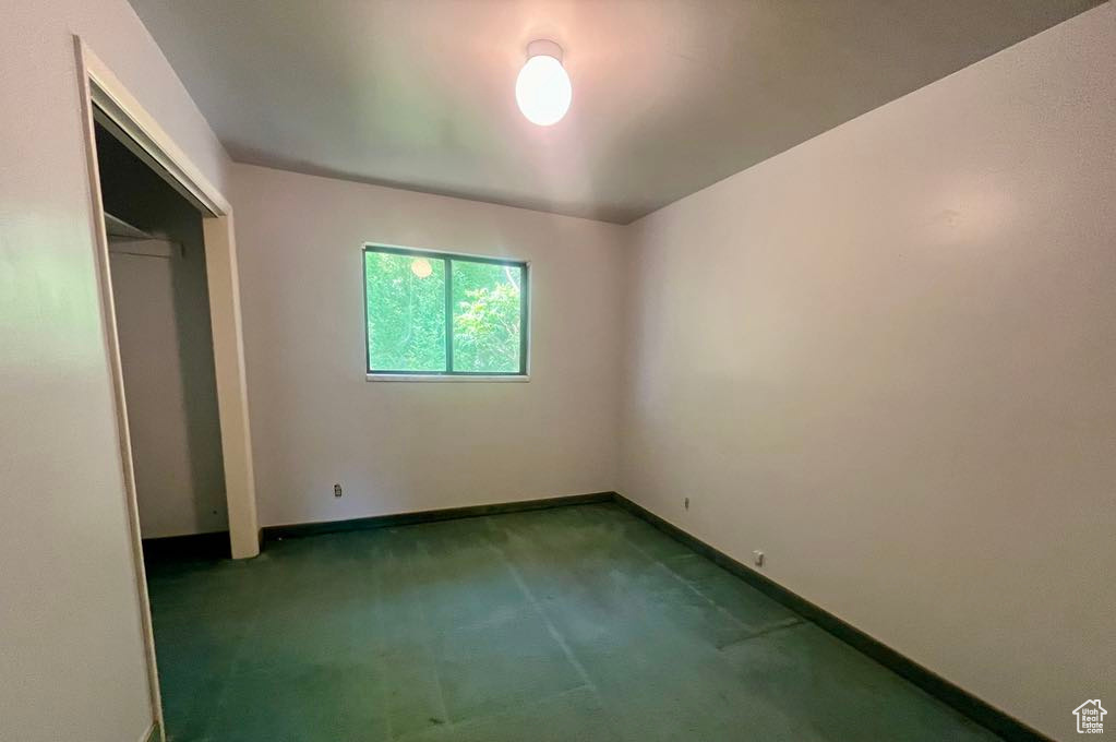 Unfurnished bedroom featuring carpet floors and a closet