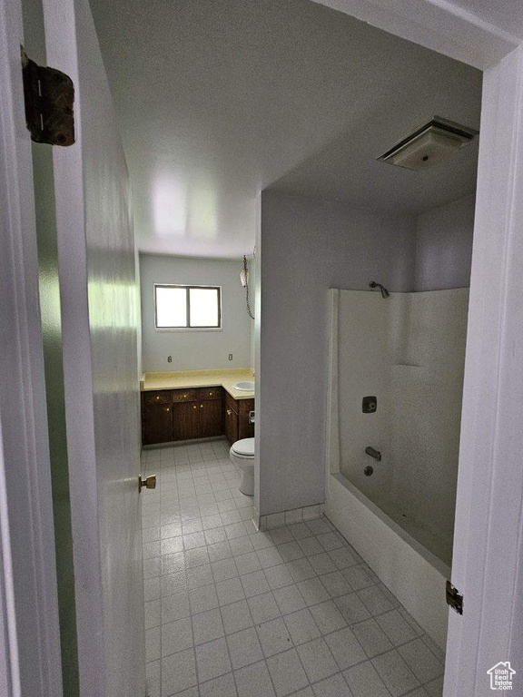 Bathroom with vanity, toilet, and  shower combination
