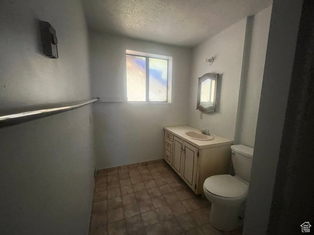 Bathroom with vanity and a textured ceiling
