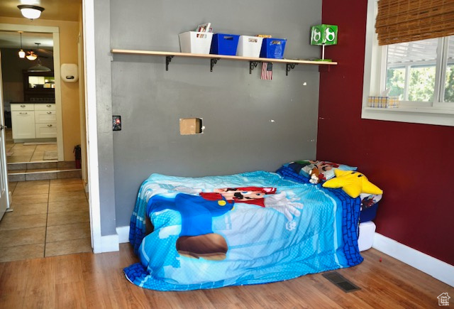Bedroom featuring wood finished floors and baseboards