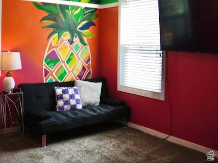Living area featuring carpet floors, a textured ceiling, and baseboards
