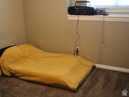 Bedroom featuring carpet flooring and a textured ceiling