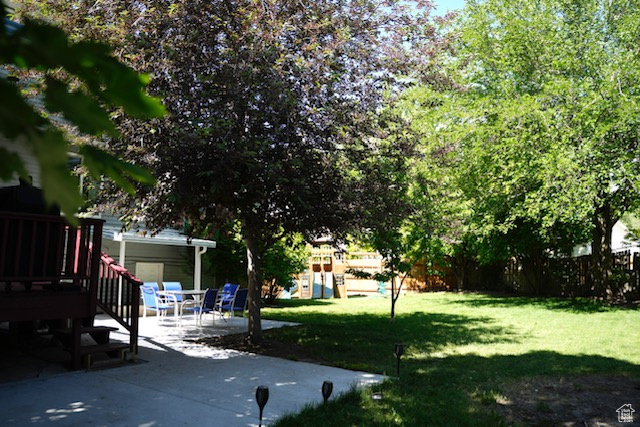 View of yard with a patio and a deck