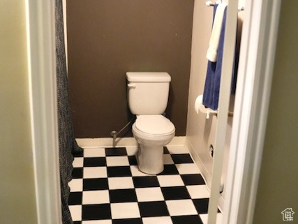 Full bath featuring tile patterned floors and toilet