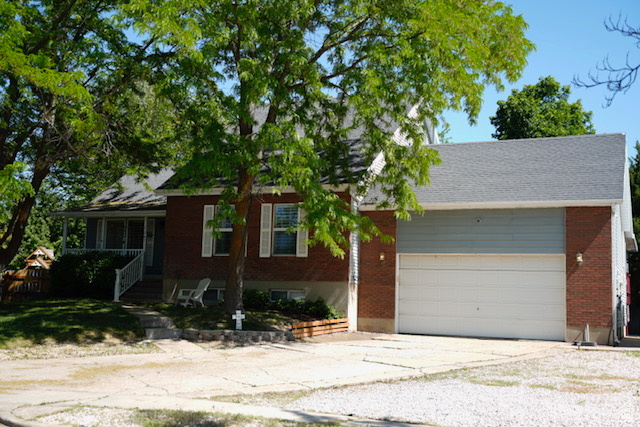Single story home featuring brick siding, concrete driveway, and an attached garage