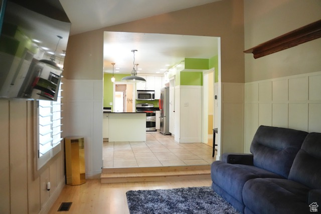 Living area with light wood-style flooring and lofted ceiling