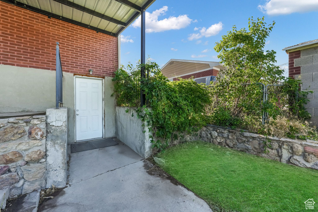 Entrance to property featuring brick siding