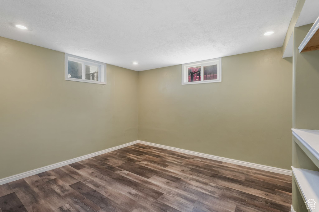 Below grade area with dark wood-style flooring, baseboards, and recessed lighting