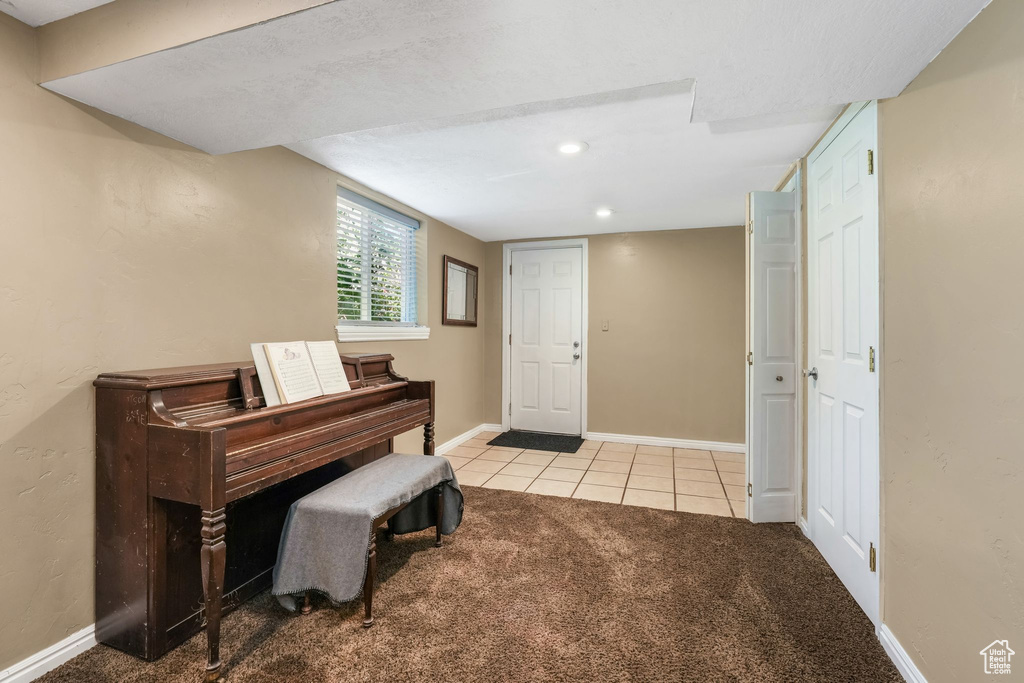Carpeted entrance foyer featuring tile patterned floors, baseboards, and recessed lighting