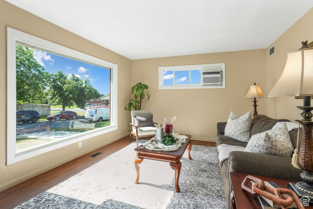 Living area with wood finished floors and baseboards
