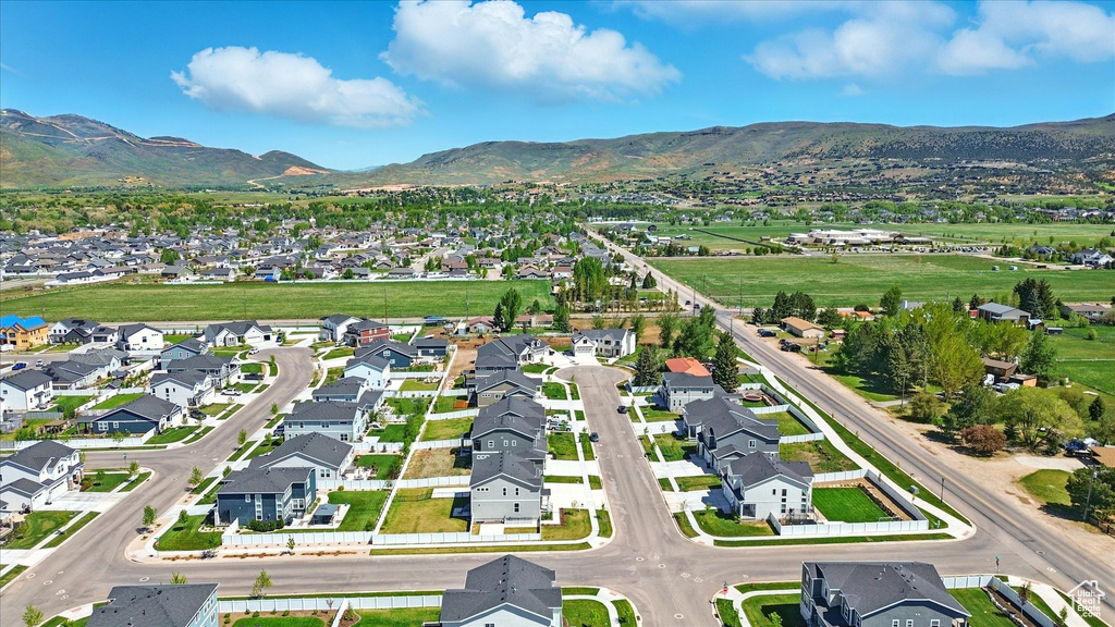 Aerial overview of property's location featuring mountains and nearby suburban area
