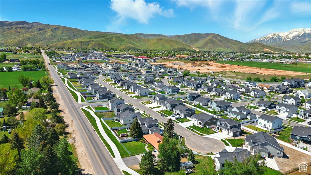 Aerial view of property's location featuring nearby suburban area and mountains