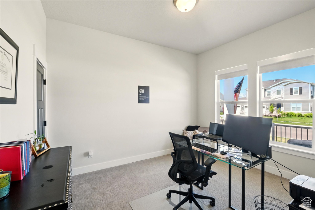 Office area featuring carpet floors and baseboards