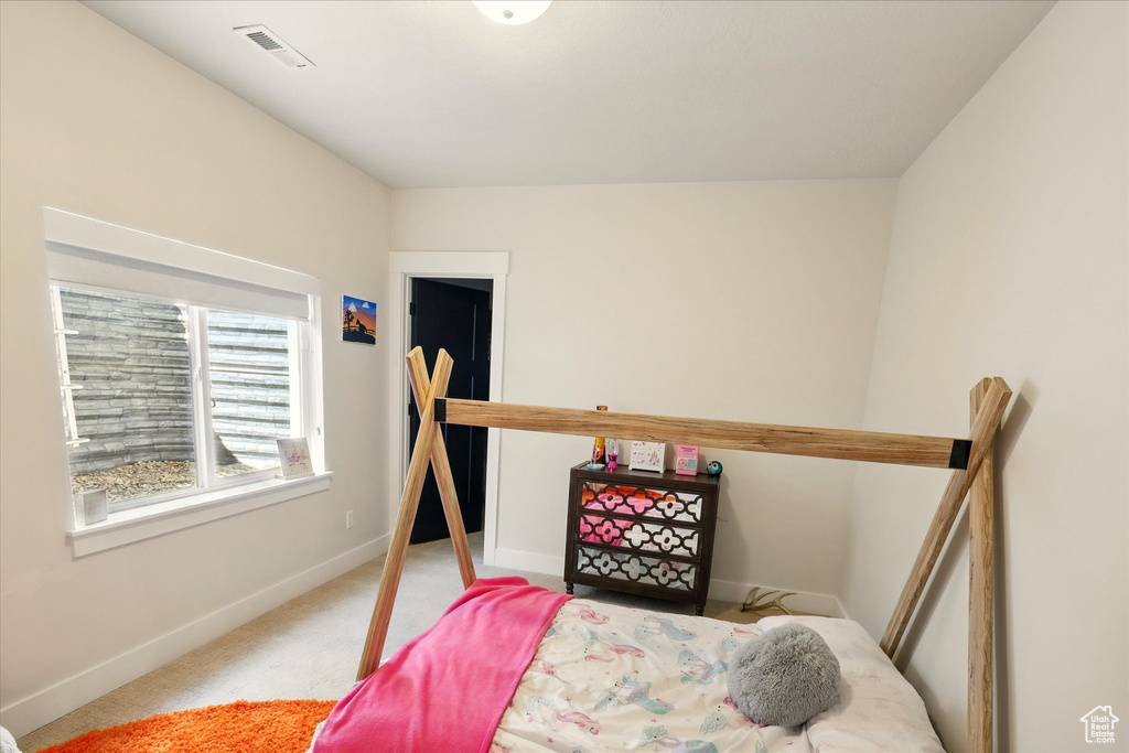 Carpeted bedroom featuring baseboards