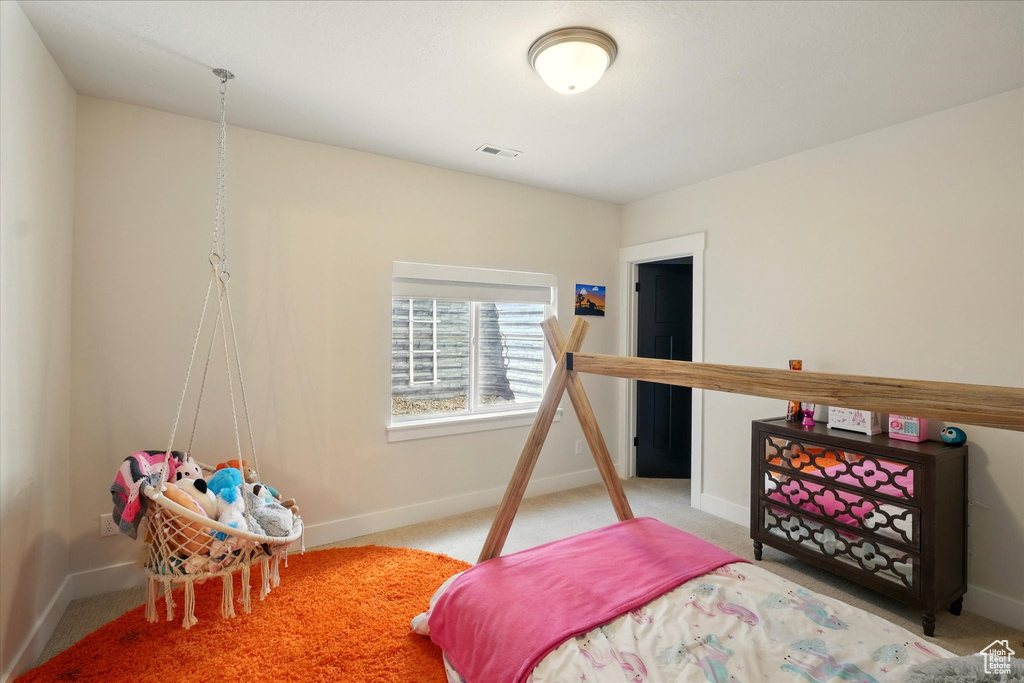 Carpeted bedroom featuring baseboards