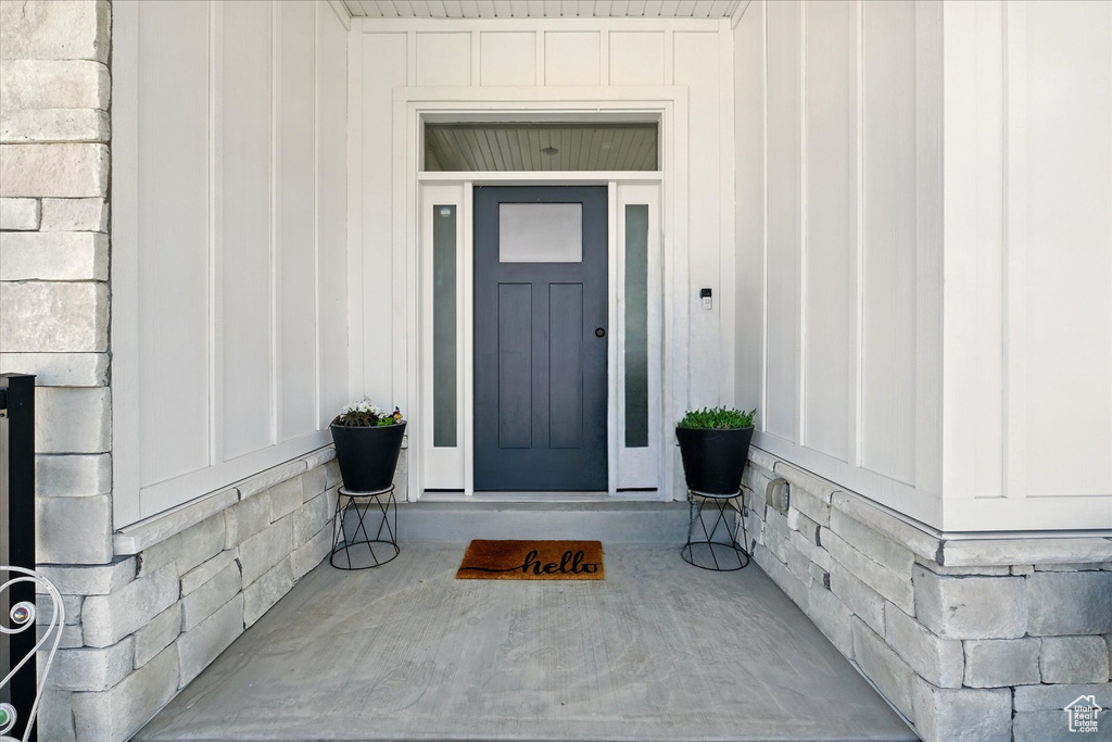 View of exterior entry featuring board and batten siding