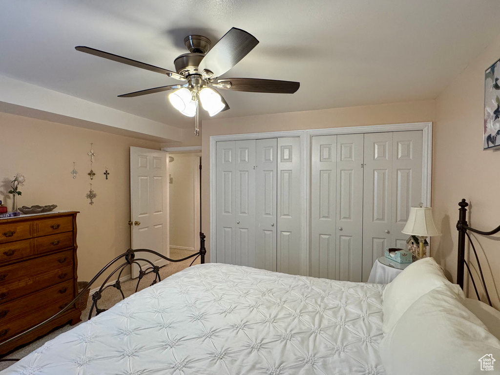 Bedroom with two closets and a ceiling fan