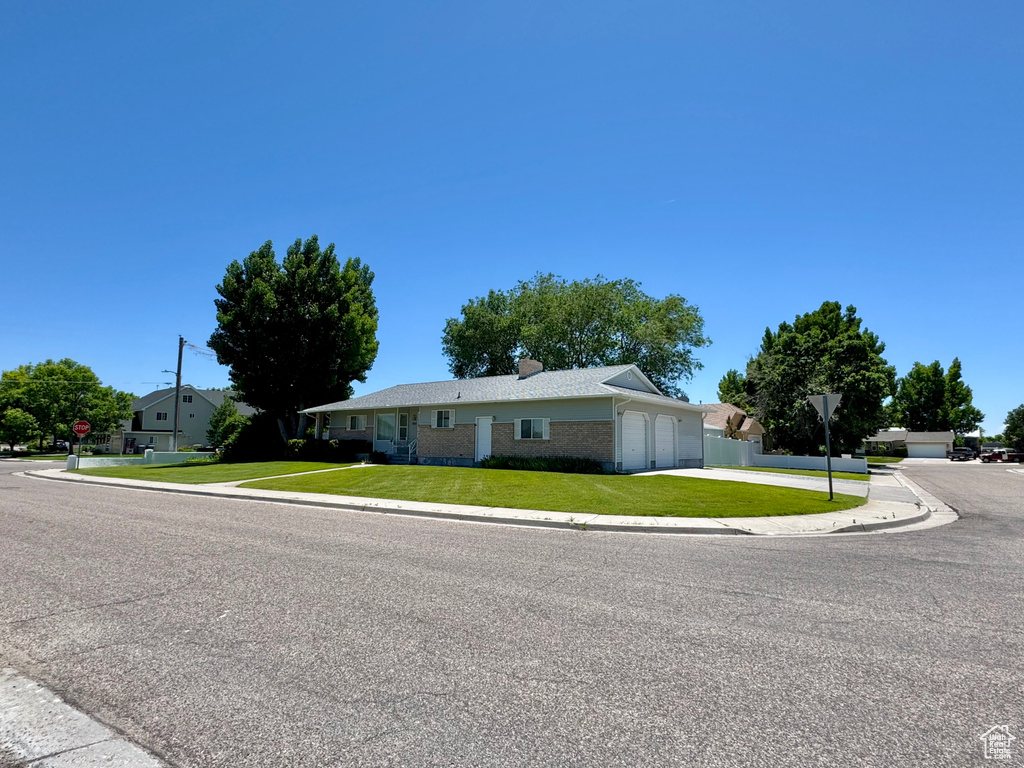 Single story home with concrete driveway, a garage, and brick siding