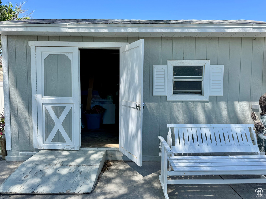 Property entrance featuring roof with shingles