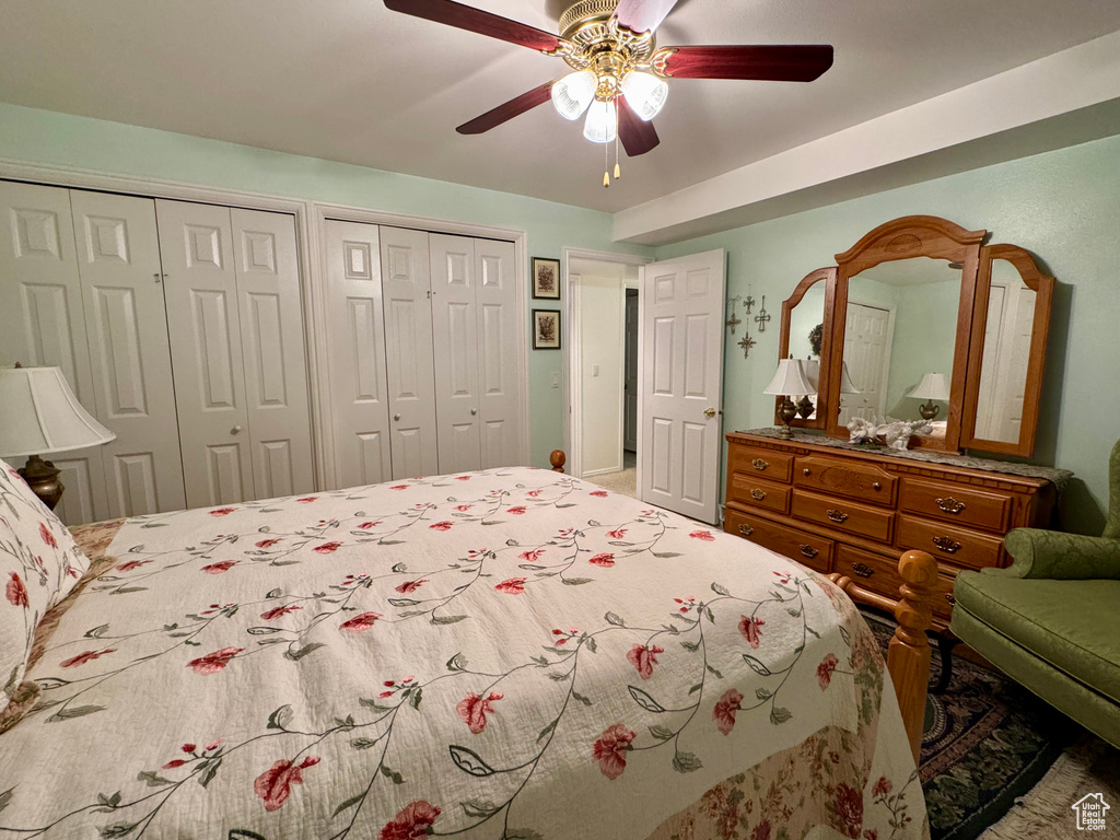 Bedroom with two closets and ceiling fan