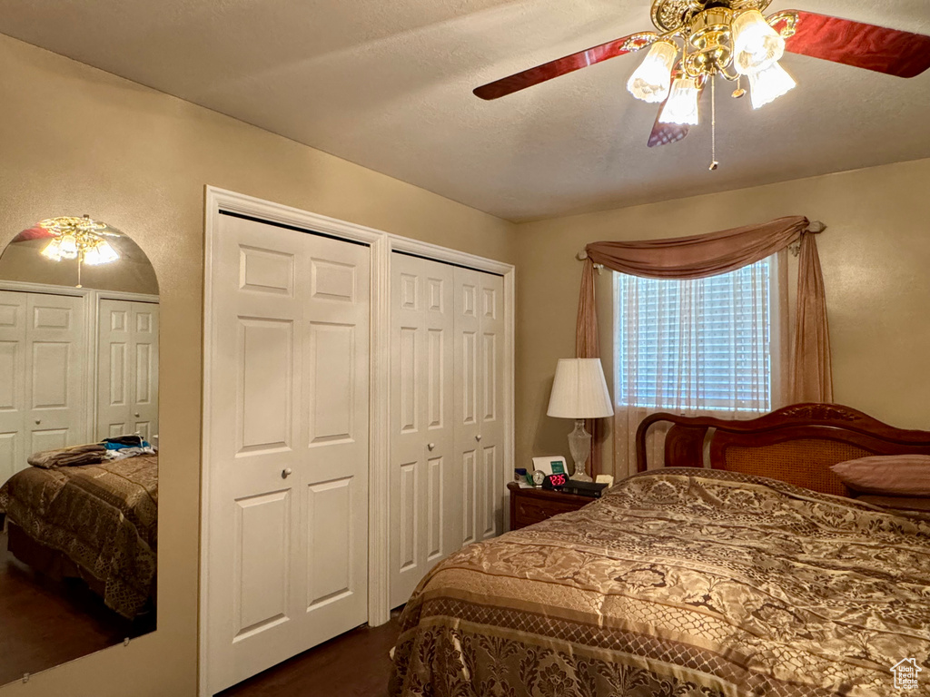 Bedroom with multiple closets and a ceiling fan