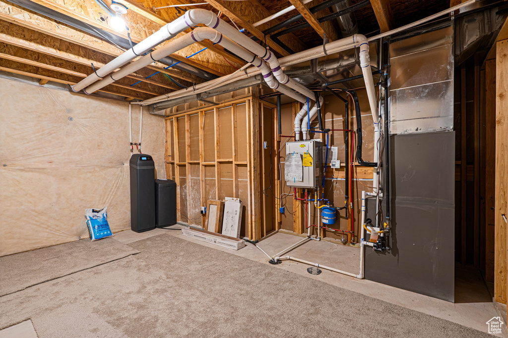 Unfinished basement featuring a water softener