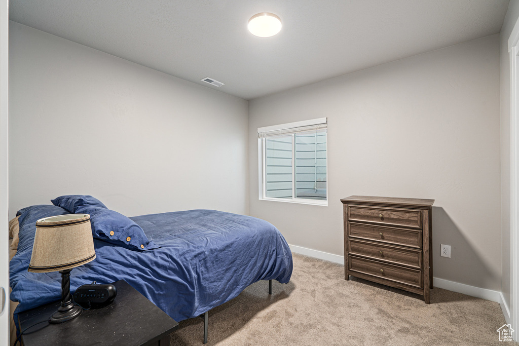 Carpeted bedroom featuring baseboards