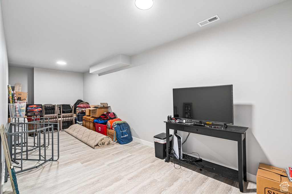 Recreation room featuring wood finished floors, baseboards, and recessed lighting