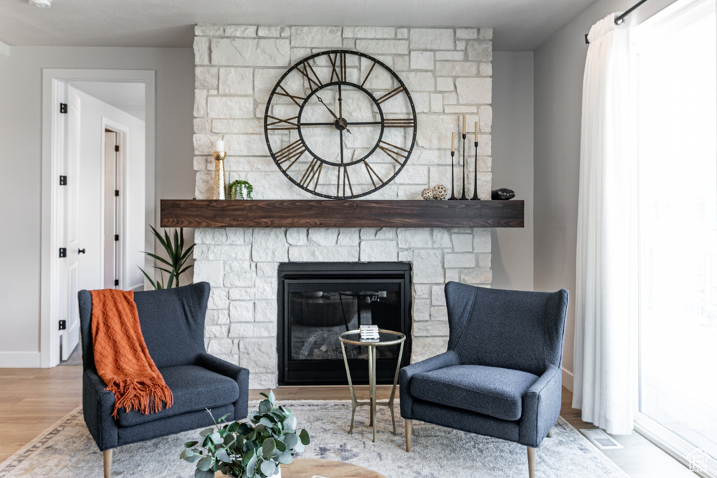 Living area with a fireplace and wood finished floors