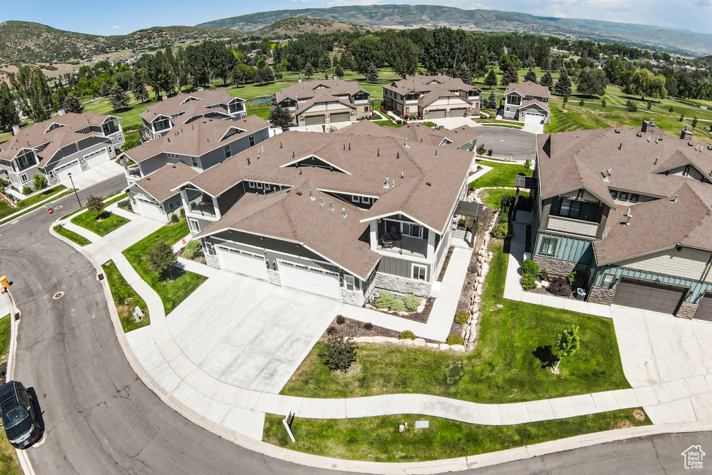 Aerial overview of property's location featuring nearby suburban area and a mountainous background