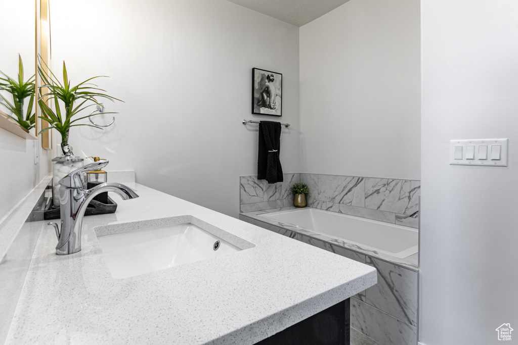 Bathroom with double vanity and a bath