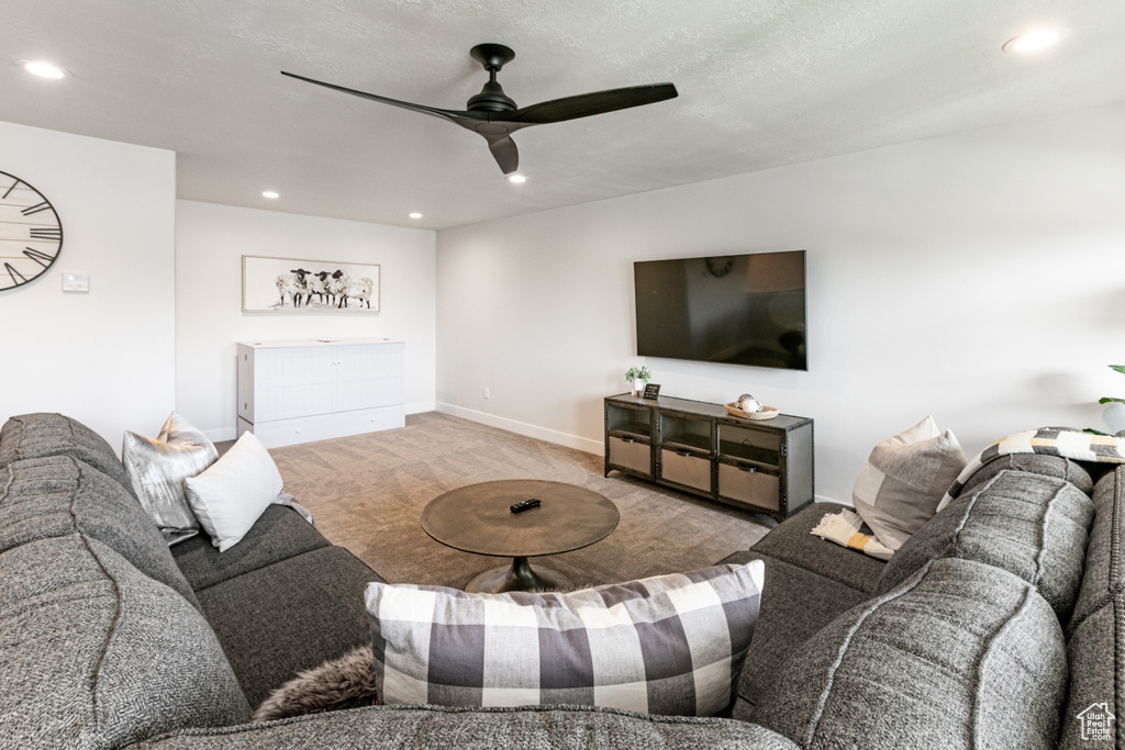 Living area with carpet, a ceiling fan, and recessed lighting
