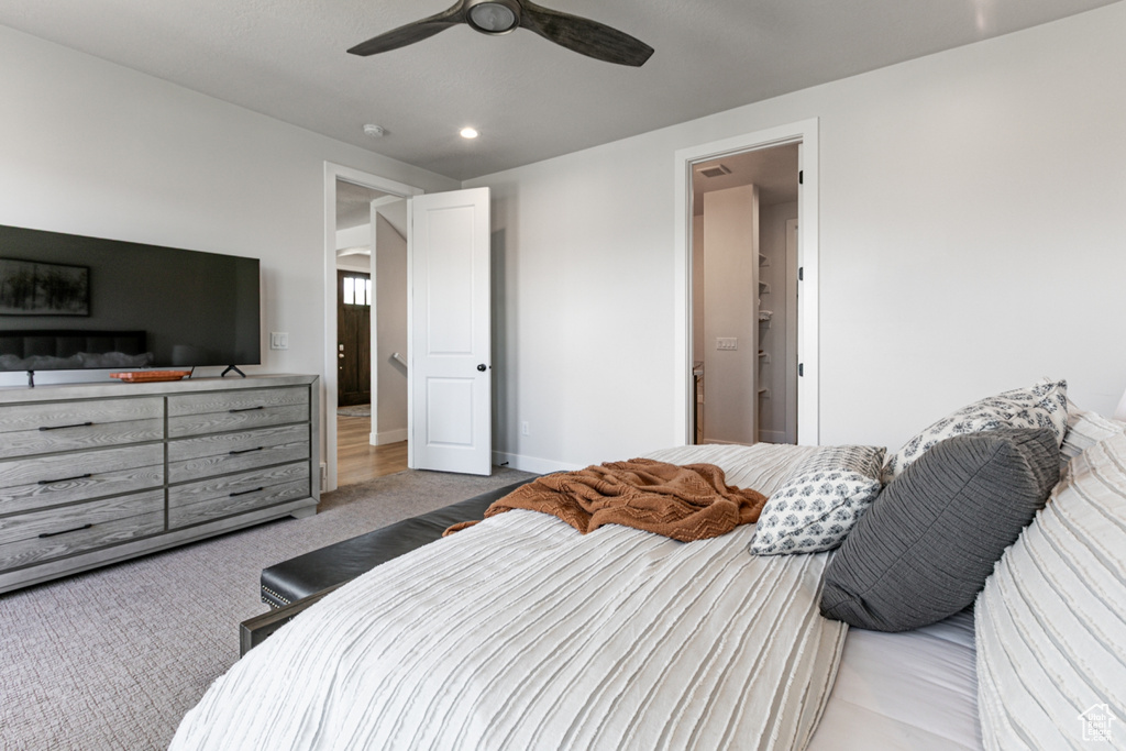 Carpeted bedroom featuring recessed lighting and a ceiling fan