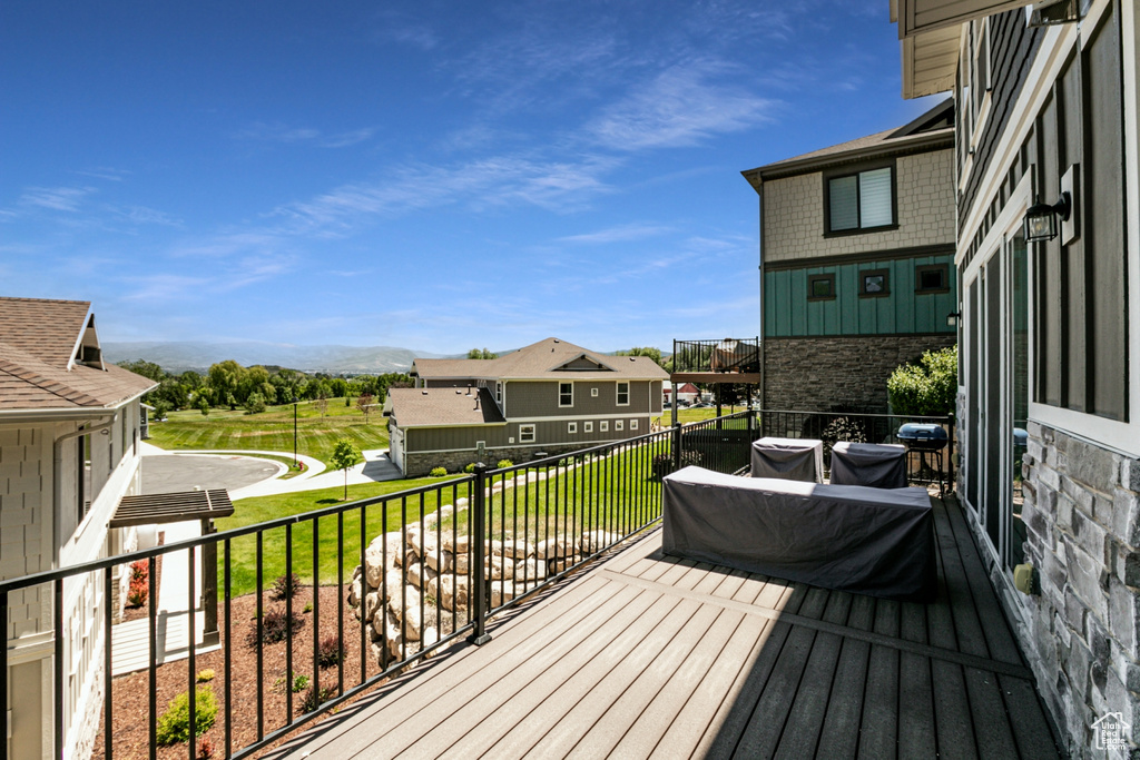 Deck with a grill and a mountain view