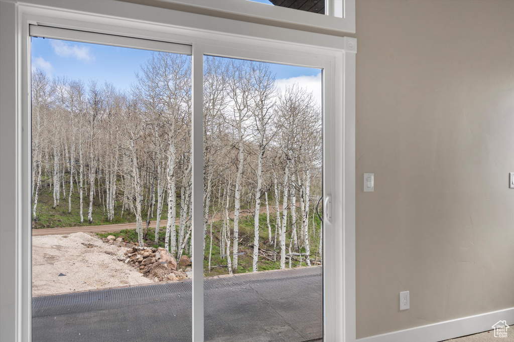 Doorway to outside with baseboards