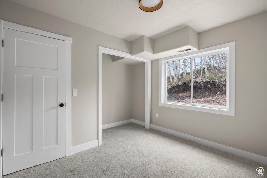 Unfurnished bedroom featuring carpet floors and baseboards