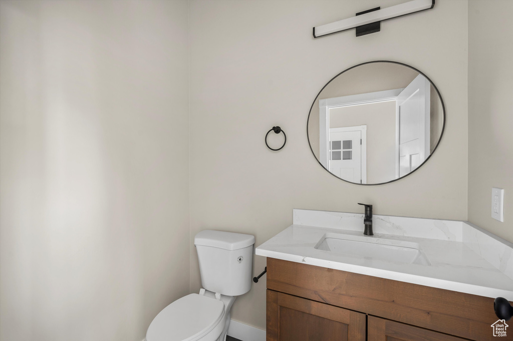 Half bathroom featuring toilet and vanity
